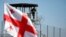 A Georgian flag waves during a rally held in support of former Georgian President Mikheil Saakashvili by representatives of the United National Movement political party outside the Rustavi prison where he is kept