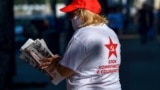 MOLDOVA -- A supporter of the Communists and Socialists bloc holds newspapers in Chisinau, on July 9, 2021. - Voters in Moldova head to the polls on July 11, 2021 in a snap parliamentary election called by new President Maia Sandu to strengthen her positi