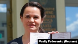 Svyatlana Tsikhanouskaya shows her registration certificate as a presidential candidate.