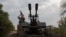 A Ukrainian serviceman of the 59th brigade mobile air defence unit monitors the sky from a military truck equipped with a Soviet made ZU-23 anti-aircraft twin autocannon during a Russian air attack near Pavlograd, Dnipropetrovsk region on July 18, 2025, 