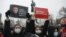 RUSSIA – People gather during a protest against the jailing of opposition leader Alexei Navalny in Pushkin square at the statue of Alexander Pushkin in the background in Moscow, Jan. 23, 202