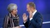 BELGIUM -- British Prime Minister Theresa May (L) and European Council President Donald Tusk talk during the familly picture at the Asem 12, Asia-Europe Meeting in Brussels, October 19, 2018