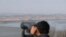 SOUTH KOREA -- A visitor uses binoculars to see the North Korea side from the unification observatory in Paju, South Korea, Monday, Jan. 1, 2018.