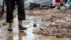 Macedonia -- A man stands in mud in front of his flood hit house in the village of Stajkovci, Skopje, The Former Yugoslav Republic of Macedonia on 07 August 2016. 