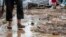 Macedonia --  A man stands in mud in front of his flood hit house in the village of Stajkovci, Skopje, The Former Yugoslav Republic of Macedonia on 07 August 2016. 