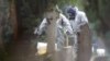 Members of the emergency services at the site of the grave of Luidmila Skripal