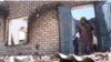 Mubora Abdukhamitova, a resident of the Kyrgyz village of Makrat, surveys the ruins of her son's house after the April 28-April 29 border conflict between Kyrgyz and Tajiks over a water canal and pumping station. 