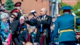 RUSSIA -- Russian President Vladimir Putin (C) gestures during the report of Defense Minister Sergei Shoigu (R) at the military parade on the Red Square in Moscow, June 24, 2020
