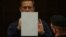 RUSSIA -- Russian opposition leader Alexei Navalny, accused of flouting the terms of a suspended sentence for embezzlement, writes inside a defendant dock during a court hearing in Moscow, Russia February 2, 2021.