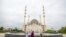 Russia -- Two women in front of a mosque in Grozny. Date unknown. 