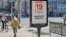 A man walks past a campaign poster put up ahead of the elections to the Russian State Duma scheduled for September 17-19