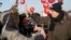 RUSSIA  -- Russian opposition politician Aleksei Navalny (R) gives a high-five to a supporter at a rally in Novokuznetsk, December 9, 2017