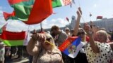 BELARUS – Supporters of Belarusian President Alexander Lukashenko hold Belarusian State Flags, as some of them wave a Russian national flag during a rally at Independent Square of Minsk, August 16, 2020