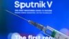 RUSSIA -- A syringe with the webpage of Russia's Sputnik V (Gam-COVID-Vac) vaccine against the coronavirus disease in the background - generic
