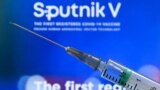 RUSSIA -- A syringe with the webpage of Russia's Sputnik V (Gam-COVID-Vac) vaccine against the coronavirus disease in the background - generic