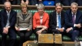 London, Britain - Britain's Prime Minister Theresa May / Britain's Prime Minister Theresa May reacts after the results of the vote on Brexit deal in Parliament in London, Britain, March 12, 2019.