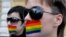 Moldova -- Two lesbians cover their lips during a silent protest action in downtown Chisinau, 27Apr2007