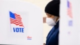 U.S. -- A person stands in a voting booth while preparing to cast a paper ballot at a polling location inside Show Place Arena in Upper Marlboro, Maryland, USA, 02 November 2020.