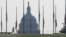 A visitor walks around the Washington monument as American flags are held at half staff in remembrance of the 20th anniversary of the September 11 attacks, on the National Mall near the U.S. Capitol in Washington, U.S., September 11, 2021. 