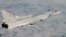 Russia -- A Russian Tupolev Tu-22M aircraft flies over an unknown location during a military exercise, undated