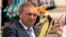 Russia --  Sochi's mayor Anatoly Pakhomov holds a torch in Sochi, May 25, 2013