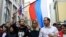RUSSIA -- Candidates to the Moscow City Duma Lyubov Sobol (C) and Ivan Zhdanov (R) attend a rally against efforts to stop opposition candidates to register for elections to the Moscow City Duma in central Moscow, July 14, 2019