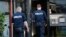 Police officers walk outside an apartment building cordoned off, in Brondby Strand, Copenhagen, Denmark, Thursday, Sept. 21, 2017.