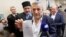 UKRAINE -- Akhtem Chiygoz (C) shows a certificate of his release, as he attends a press conference together with Ilmi Umerov (R), after their arriving from Turkey at the International airport Boryspil near Kyiv, October 27, 2017