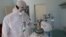 KOSOVO: A health worker next to an oxygen cylinder with which covid-19 patients are treated.