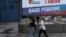 RUSSIA -- People walk past a billboard poster promoting the 2020 Russian constitutional referendum and reading "All-Russian voting; 1 July; Our Dicision" on a street in Novosibirsk, June 10, 2020