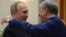 Kyrgyzstan -- Kyrgyz President Almazbek Atambaev (R) embraces his Russian counterpart Vladimir Putin during a Commonwealth of Independent States (CIS) leaders summit at the Ala-Archa state residence in Bishkek, September 16, 2016