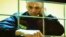(FILES) Opposition leader Alexei Navalny appears on a screen set up at a courtroom of the Moscow City Court via a video link from his prison colony during a hearing of an appeal against his nine-year prison sentence he was handed in March after being foun