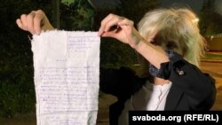 Lawyer Lyudmila Kazak holds up a complaint that one of her clients wrote and handed over to her in Minsk on September 25. Kazak herself was abducted and later found guilty of "failing to obey" police at an opposition rally that she says she didn't even attend.