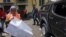 Chechnya -- People crowd outside the Committee Against Torture's headquarters following an attack on the premises in Grozny, June 3, 2015
