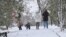 UKRAINE - Children play snowballs while parents stroll down the alley, Sapun Gora, Sevastopol, 13Feb2021
