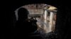 Пожарный тушит возгорание в харьковском доме культуры, пострадавшем от российского ракетного удара 18 августа 2022 года