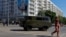 FILE PHOTO: A vehicle drives past a mural in Mariupol