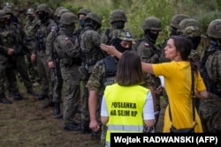 Not far from northeastern Poland's border with Belarus, Polish politician Klaudia Jachira on August 20, 2021 tries to negotiate with border guards about illegal migrants believed to be from Afghanistan.