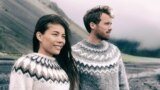 Winter nature panoramic people couple wearing icelandic wool handknit knitted sweaters on outdoor beach banner. Fashion models background