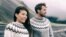 Winter nature panoramic people couple wearing icelandic wool handknit knitted sweaters on outdoor beach banner. Fashion models background