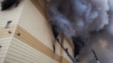 RUSSIA -- Members of the Emergency Situations Ministry work to extinguish a fire in a shopping mall in the Siberian city of Kemerovo, March 25, 2018