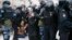 RUSSIA -- In this Jan. 23, 2021, file photo, police detain a man as another policeman stops a young woman, center, during a protest against the jailing of opposition leader Alexei Navalny in Moscow, Russia. 