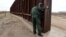 U.S. -- A U.S. Border patrol agent opens a gate on the fence along the Mexico border to allow vehicles pass in El Paso, January 17, 2017
