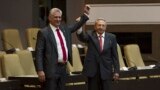 CUBA -- Outgoing Cuban President Raul Castro (R) raises the arm of Cuba's new President Miguel Diaz-Canel after he was formally named by the National Assembly, in Havana, April 19, 2018