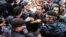 RUSSIA -- Opposition activists clash with police as they attend a rally against efforts to stop opposition candidates to register for the elections to the Moscow City Duma during a march in central Moscowm July 14, 2019