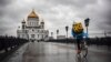 RUSSIA -- A food delivery courier rides in front of Christ-the-Savior cathedral in central, the main Russian Orthodox church in central Moscow, June 2, 2020
