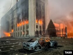 A burnt car is seen by the mayor's office in Almaty on January 5, 2022.