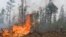 RUSSIA -- Volunteers and employees of the Yakutlesresurs extinguish a forest fire outside Magaras village 87 km. (61 miles) west of Yakustk, the capital of the republic of Sakha also known as Yakutia, July 18, 2021