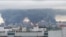 Thick plumes of smoke with flames rise from an oil refinery in Moscow