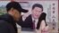 CHINA -- People walk past a poster of Chinese President Xi Jinping beside a street in Beijing, February 26, 2018